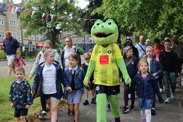 St Peter’s pupils, families and Harry Gator walking to school