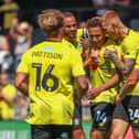 Lewis Richards, centre, is congratulated by his Harrogate Town team-mates after firing the Sulphurites into a 26th-minute lead against Huddersfield Town. Pictures: Matt Kirkham