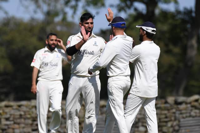 Sajid Khan is congratulated by his Blubberhouses team-mates after taking a wicket.