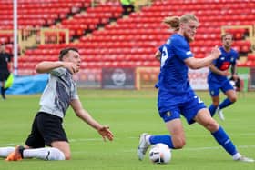 Harrogate Town striker Luke Armstrong steals the ball off Gateshead's Carl Magnay on the way to putting his side 2-0 up in Saturday's pre-season friendly at the International Stadium. Pictures: Matt Kirkham