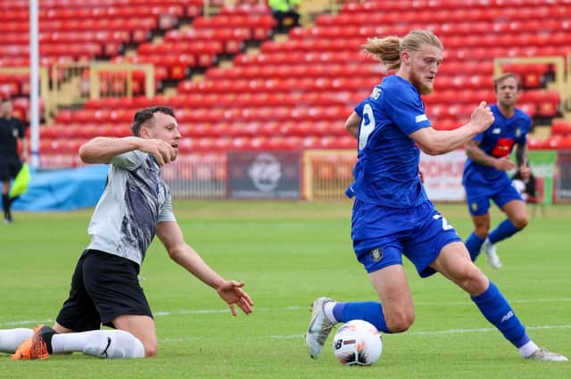 Harrogate Town striker Luke Armstrong steals the ball off Gateshead's Carl Magnay on the way to putting his side 2-0 up in Saturday's pre-season friendly at the International Stadium. Pictures: Matt Kirkham