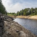 19 July 2022........ The submerged walls of buldings and boundary walls aswell as the stumps of felled trees emerge from the low water levels at Thruscross Reservoir near Harrogate as the long spell without significant rainfall continues. Picture Tony Johnson