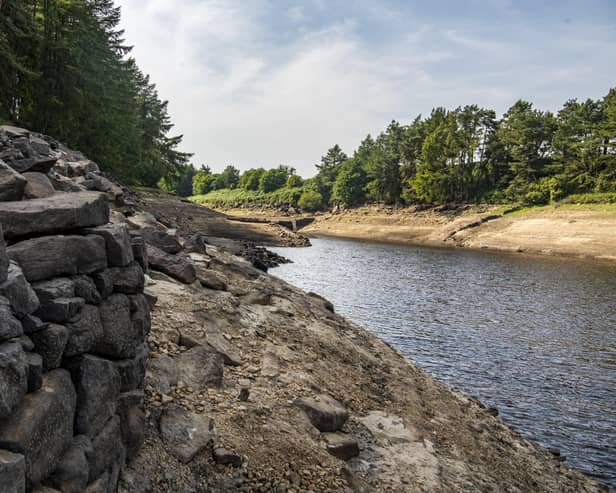 19 July 2022........ The submerged walls of buldings and boundary walls aswell as the stumps of felled trees emerge from the low water levels at Thruscross Reservoir near Harrogate as the long spell without significant rainfall continues. Picture Tony Johnson