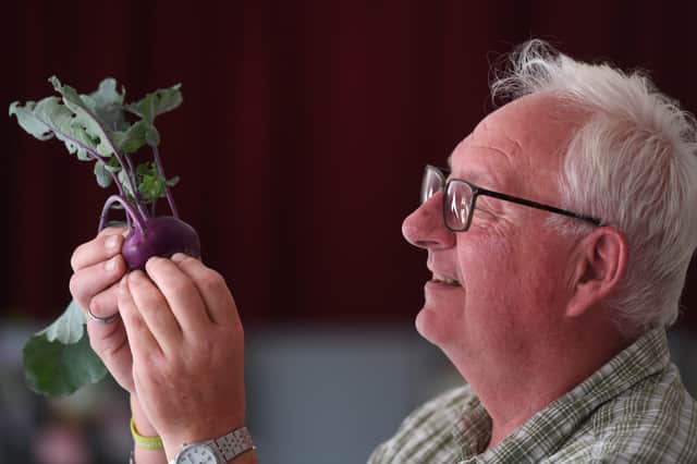23rd July 2022
Hampsthwaite Feast.
Pictured Rob Gooderidge views a Kohl Rabi while judging the vegetables
Picture Gerard Binks