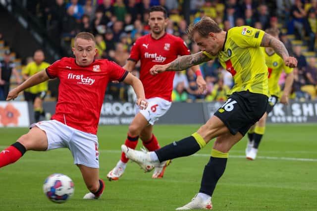 Harrogate Town midfielder Alex Pattison takes aim at the Swindon Town goal during Saturday's League Two clash at Wetherby Road. Pictures: Matt Kirkham