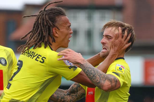 Harrogate Town defender Miles Welch-Hayes, left, celebrates with team-mate Alex Pattison after setting him up to score the opening goal in Saturday's 3-0 League Two triumph over Swindon.