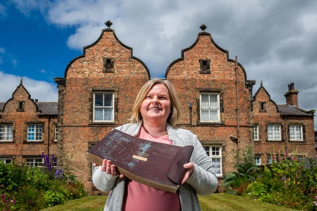 Ripon Museums Trust Community Curator Dr Laura Allan at The Workhouse Museum, holding the orginal Application & Report Book for the Workhouse. Picture James Hardisty