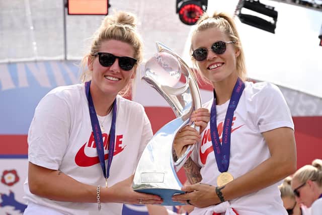 Rachel Daly and Millie Bright with the UEFA Women's EURO 2022 trophy during the England Women's team celebration at Trafalgar Square on Monday