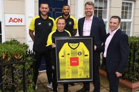 Harrogate Town footballers have cut the ribbon at the official opening Aon's new premises