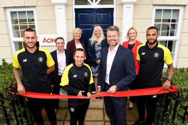 Harrogate Town footballers have cut the ribbon at the official opening Aon's new premises