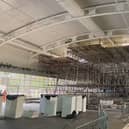 A huge scaffolding structure has been erected inside the swimming pool.