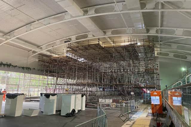 A huge scaffolding structure has been erected inside the swimming pool.