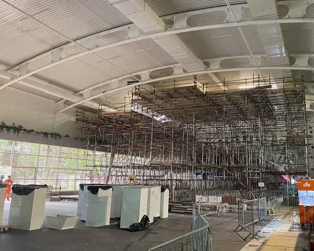 A huge scaffolding structure has been erected inside the swimming pool.