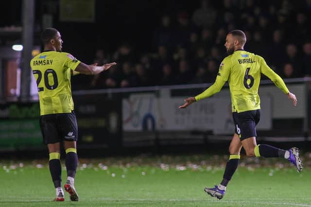 Warren Burrell, right, is congratulated by team-mate Kayne Ramsay after netting Harrogate Town's second equaliser against Carlisle United in midweek.