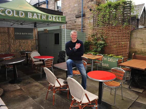 Welcome! Pictured ready to open on 12th April is cafe/deli owner Peter Woolrich who is pictured in his outside dinning area at the Cold Bath Deli, Harrogate. (Picture Gerard Binks)