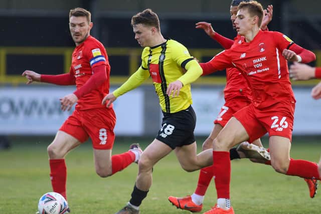 A trio of Orient players converge on Josh McPake in a bid to stop the flying winger in his tracks.