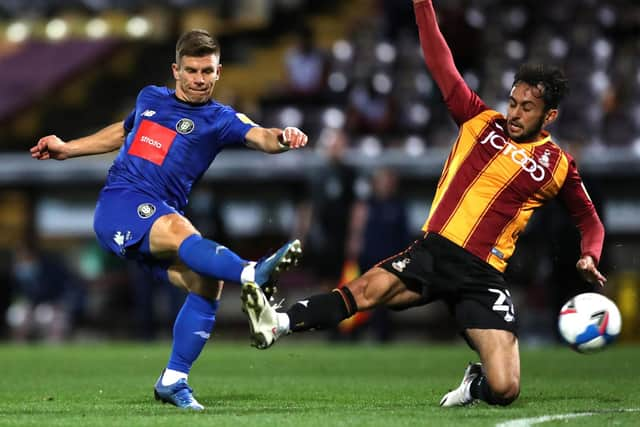 Levi Sutton challenges former team-mate Lloyd Kerry during Bradford City's 1-0 defeat to Harrogate Town at Valley Parade.