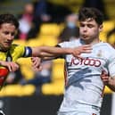 Harrogate Town captain Josh Falkingham fends off Bradford City's Connor Wood. Pictures: Jonathan Gawthorpe