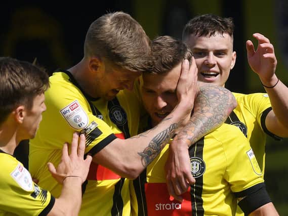 Jon Stead embraces strike partner Jack Muldoon after the latter opened the scoring during Harrogate Town's win over Bradford City. Pictures: Jonathan Gawthorpe