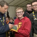 Chief Scout Bear Grylls with  scouts at Bramhope as part of their Youth Commissioners Challenge badge  Bear Grylls signs for Thomas Bliss, 13