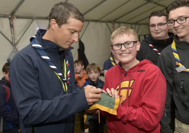 Chief Scout Bear Grylls with  scouts at Bramhope as part of their Youth Commissioners Challenge badge  Bear Grylls signs for Thomas Bliss, 13
