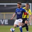 Harrogate Town defender Will Smith closes down Oldham Athletic's Conor McAleney at the EnviroVent Stadium. Picture: Matt Kirkham