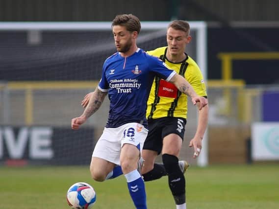 Harrogate Town defender Will Smith closes down Oldham Athletic's Conor McAleney at the EnviroVent Stadium. Picture: Matt Kirkham