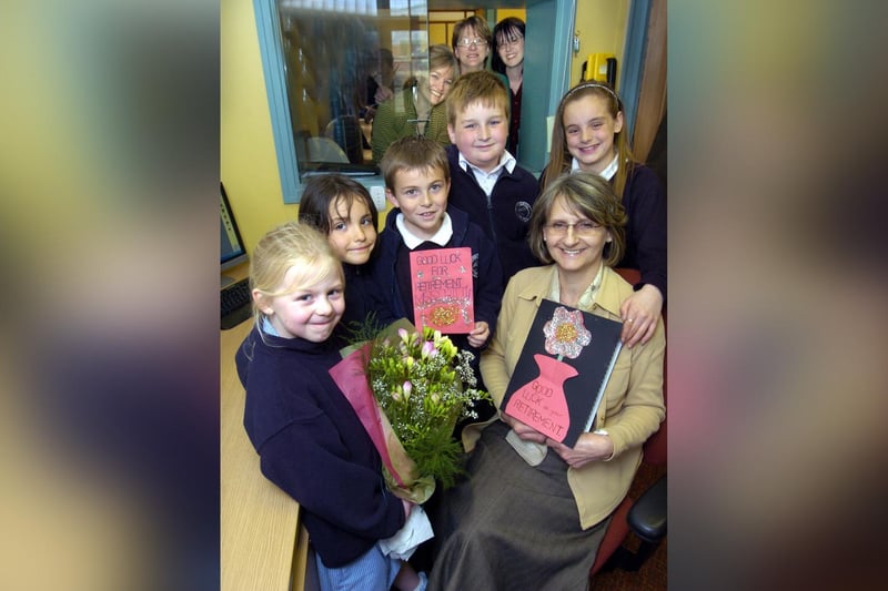 Children wish Hinderwell School secretary Janet Critten good luck for her retirement.