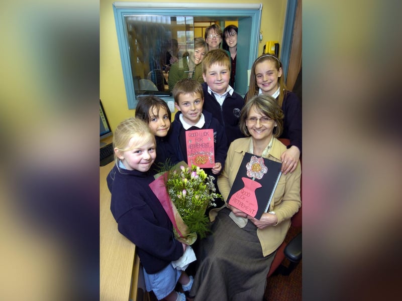 Children wish Hinderwell School secretary Janet Critten good luck for her retirement.