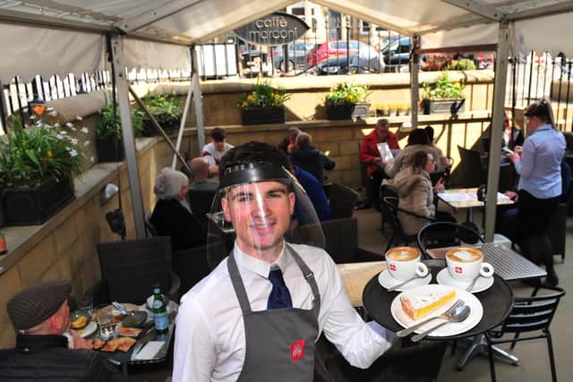 Life under canvas - John Porritt serves drinks and cakes at the Caffe Marconi in Harrogate as lockdown rules ease. (Picture Gerard Binks)