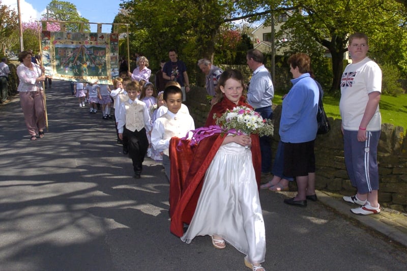 This image was taken at Glasshouses May Day celebration in 2005. It shows the queen leading the parade.