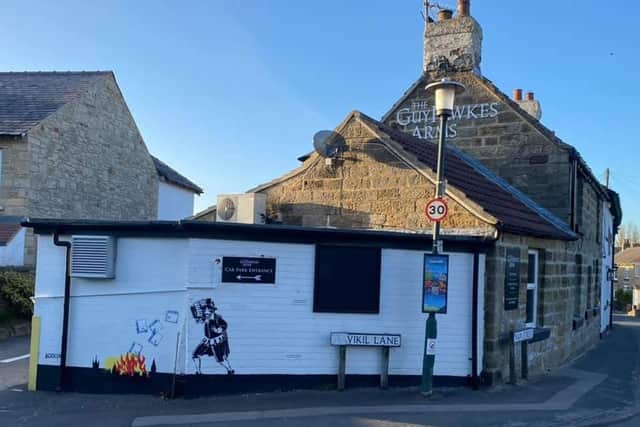Is it a real Banksy or not? The mural on the side of the Guy Fawkes Arms pub in Scotton. (Picture by Charles Mackenzie)