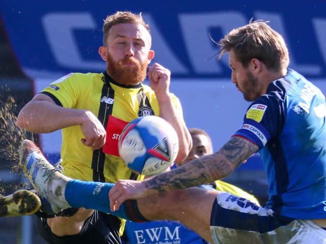 George Thomson competes for the ball with Carlisle United's Nick Anderton. Pictures: Matt Kirkham