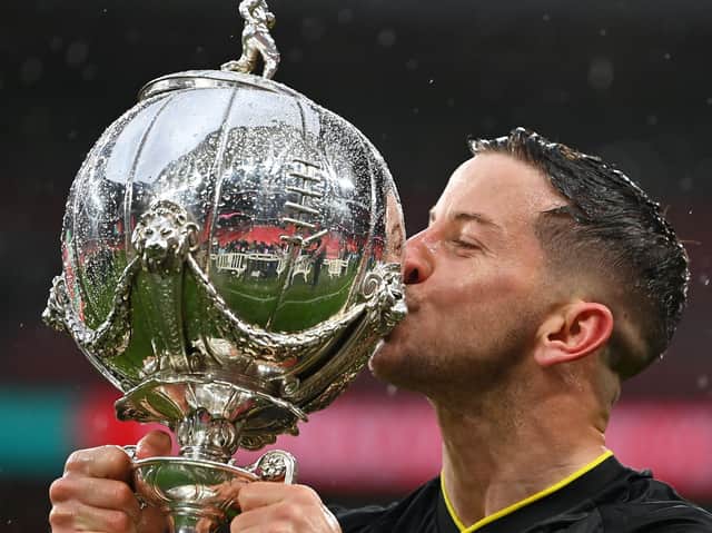 Harrogate Town captain Josh Falkingham with the FA Trophy. Pictures: Getty Images