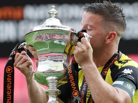 Harrogate Town captain Josh Falkingham kisses the National League play-off final winners' trophy following his side's 3-1 success over Notts County at Wembley Stadium. Picture: Getty Images