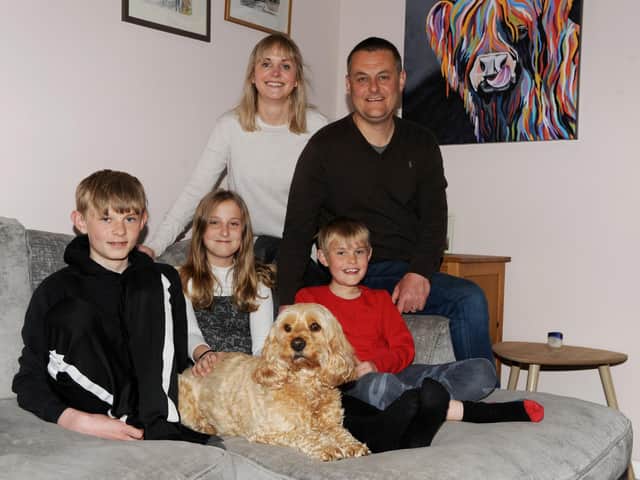Reunited: The wandering Seth the Cockapoo back with his owners dad Nick Wield, mum Anna and children James, 14; Daisy, 11; and William, nine. (Picture Gerard Binks)