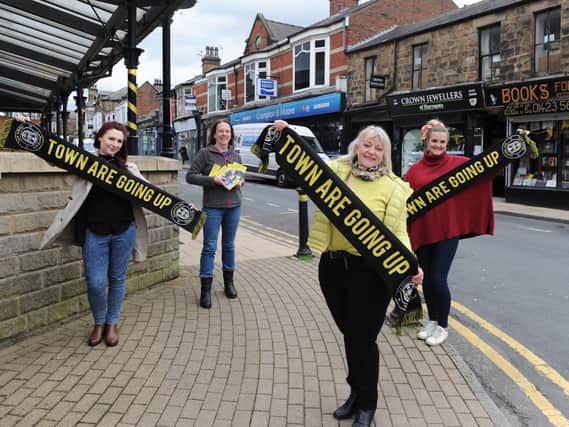 Harrogate Town is good for business - Flying the flag for town's football heroes are members of Commercial Street Retailers Group Eve Melia of AC Gallery, Jenny Smart of Books for All, Sue Kramer of Crown Jewellers and Alex Clarke of Foxy Antiques and Interiors.