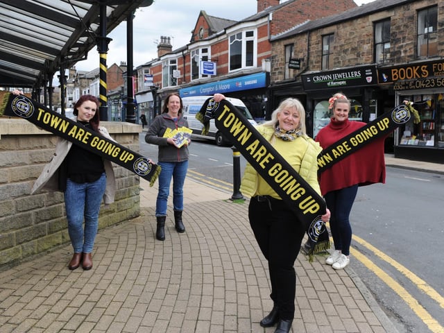 Harrogate Town is good for business - Flying the flag for town's football heroes are members of Commercial Street Retailers Group Eve Melia of AC Gallery, Jenny Smart of Books for All, Sue Kramer of Crown Jewellers and Alex Clarke of Foxy Antiques and Interiors.
