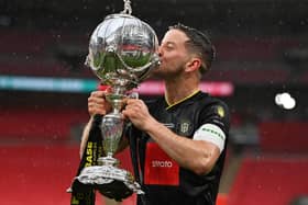 Victory tastes sweet -  Harrogate Town captain Josh Falkingham celebrates with the FA Trophy after Town beat Concord Rangers 1-0 at Wembley Stadium