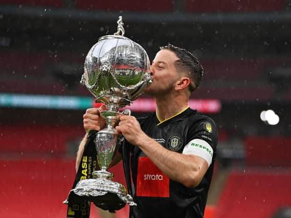 Victory tastes sweet -  Harrogate Town captain Josh Falkingham celebrates with the FA Trophy after Town beat Concord Rangers 1-0 at Wembley Stadium