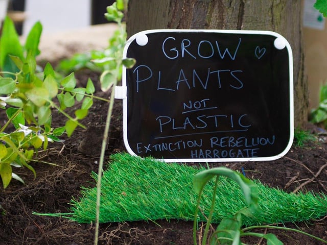 Planter controversy in Harrogate town centre - The plastic grass suddenly disappeared to be replaced by real soil and a poem by Harrogate Extinction Rebellion.
