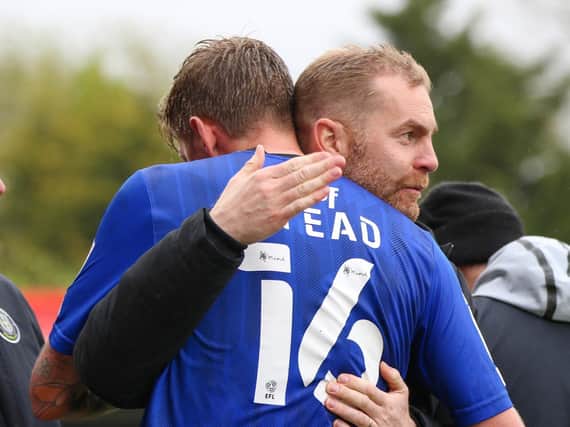 Jon Stead and Harrogate Town manager Simon Weaver embrace after the veteran striker was substituted at Cheltenham on what was the final appearance of his 19-year playing career. Picture: Matt Kirkham