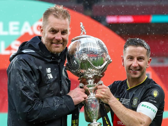 Harrogate Town manager Simon Weaver and captain Josh Falkingham with the FA Trophy at Wembley Stadium. Picture: Matt Kirkham