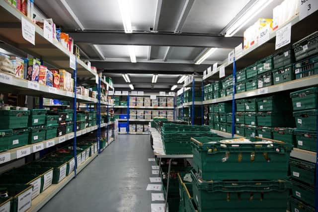 Shelving full of food to distribute at a foodbank.