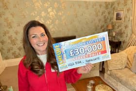 People’s Postcode Lottery ambassador Judie McCourt with the cheque for £30,000.