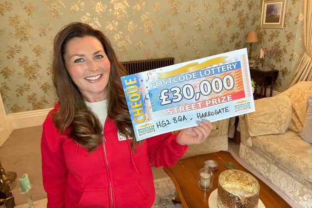 People’s Postcode Lottery ambassador Judie McCourt with the cheque for £30,000.