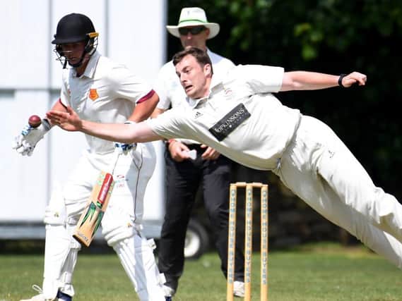 Beckwithshaw CC's Oliver Hotchkiss attempts to take a catch off his own bowling during Saturday's defeat to local rivals Bilton. Pictures: Gerard Binks