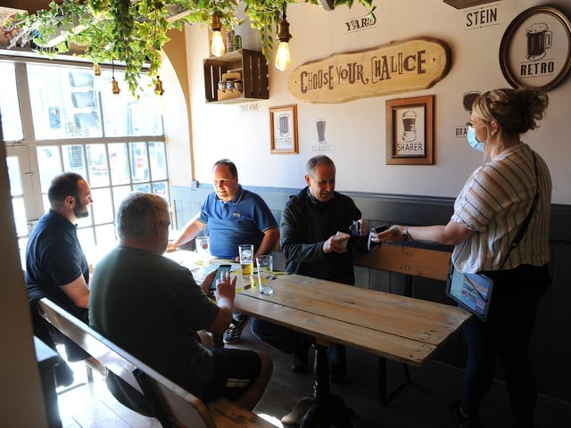Bar manager Jade Lacey serving the pints indoors at Devonshire Tap House pub in Harrogate which reopened in stage three of the roadmap after months of being mothballed. Picture Gerard Binks
