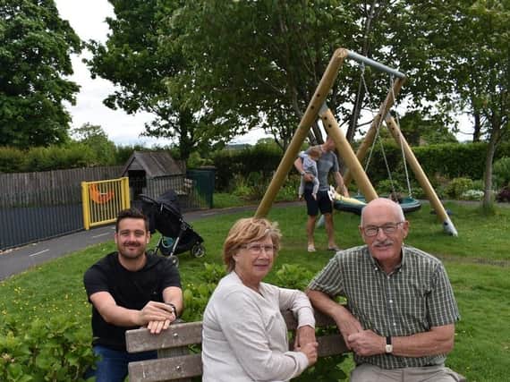 Playground refurbishment - Lewis Stokes of The Banks Group with Mary and John Hopkins of the Almscliffe Villages Community Association.