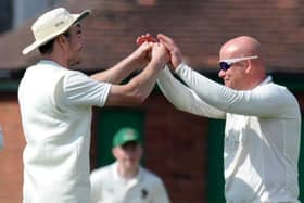 Harrogate CC skipper Will Bates, left, congratulates spinner Dominic Bradburne, who took three wickets during Saturday's win against York. Picture: Gerard Binks